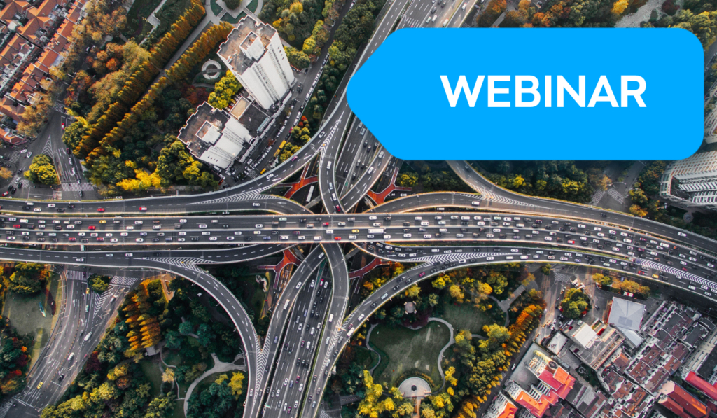 Aerial view of a massive highway interchange during rush hour with hundreds of vehicles densely packed across multiple lanes, showcasing urban traffic congestion and infrastructure complexity.