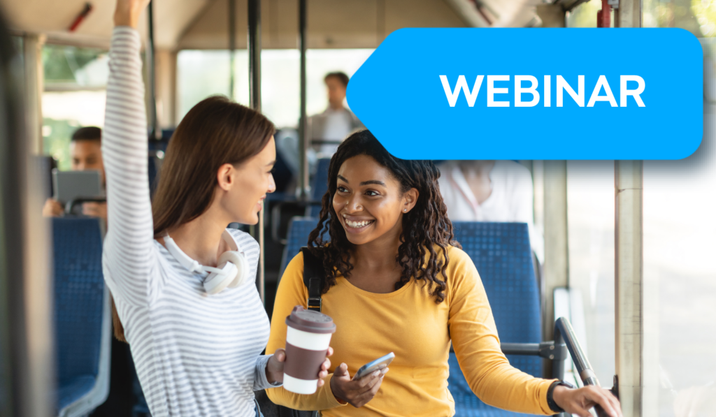 Two young women chat on public transit, one holding a coffee cup while smiling at her friend. A blue webinar label overlays the casual commute scene.