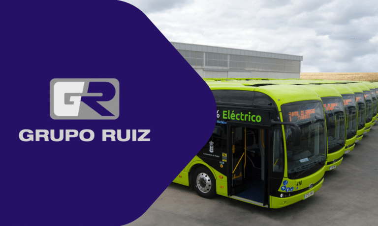 Grupo Ruiz electric buses lined up in bright lime-green livery, featuring the company logo and "Eléctrico" designation, representing sustainable public transportation solutions.