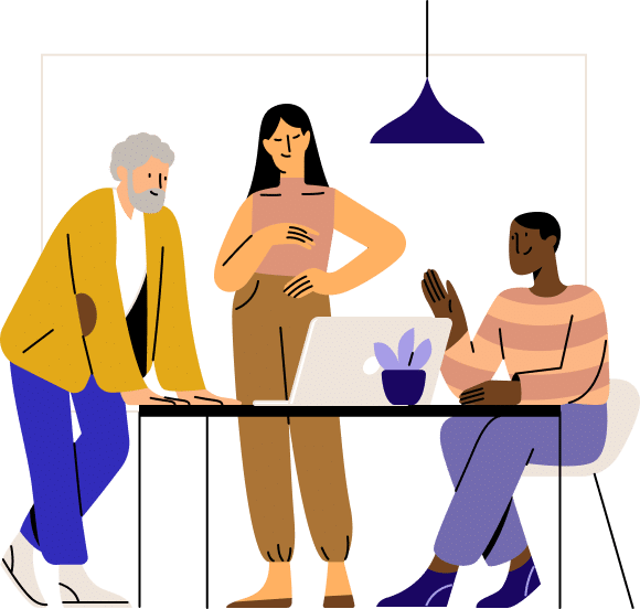 Three women collaborate around a table in a modern office, discussing work on a laptop while a potted plant and pendant lamp create a professional workspace atmosphere.