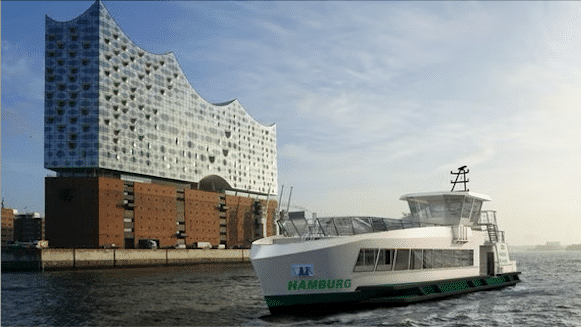 A modern white ferry boat named Hamburgo operates near Hamburg's iconic Elbphilharmonie concert hall, showcasing the city's contemporary architecture and waterfront transport infrastructure.