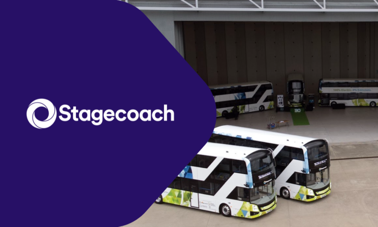 Stagecoach buses parked in a depot facility, featuring white and blue electric buses with yellow safety markings on the front bumpers, showcasing sustainable public transportation.
