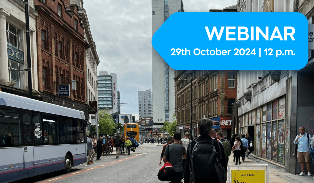Webinar announcement for October 29th, 2024 at 12 p.m. overlaid on a busy urban street scene with pedestrians, shops, and public transportation in what appears to be a UK city center.