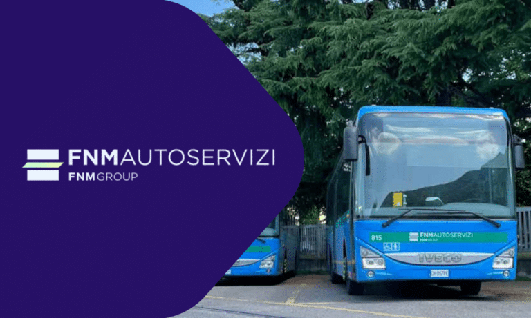 FNM Autoservizi bus fleet in blue and green livery parked outdoors with trees in background, showcasing public transportation services for the FNM Group company.