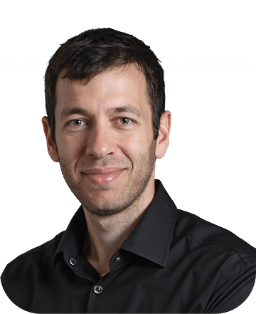 Professional headshot of a man wearing a black button-up shirt against a white background. He has dark hair, a friendly expression, and appears to be in a corporate or business setting.