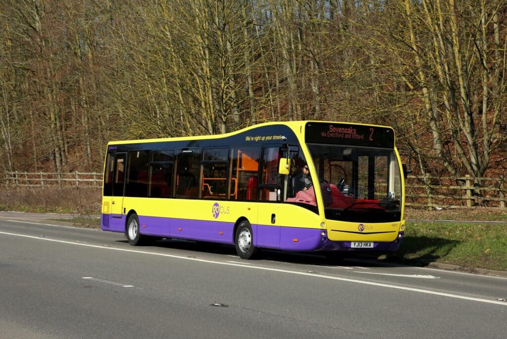 A yellow and purple Go Bus travels along a tree-lined road, displaying route 2 to Gateshead, Birtley and Offord on its destination display.