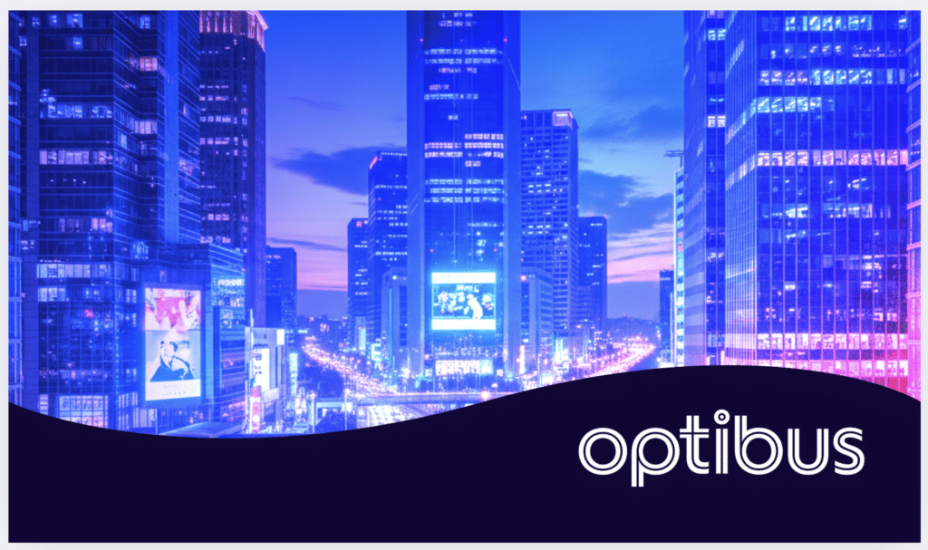 Neon-lit cityscape at twilight featuring towering skyscrapers with glowing windows, digital billboards, and the Optibus logo. Purple and blue lighting creates a vibrant urban atmosphere during