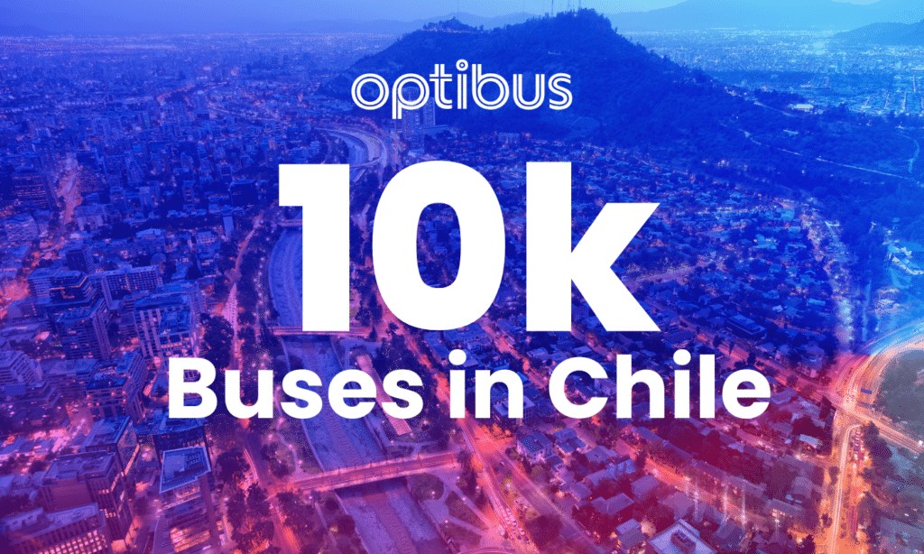 Optibus celebrates 10,000 buses operating in Chile with a vibrant aerial cityscape of Santiago at dusk, showcasing urban infrastructure and transportation networks.