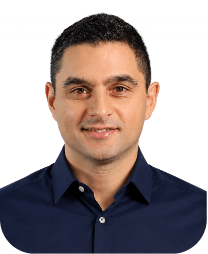 Professional headshot of a man wearing a dark navy blue button-up shirt, smiling at the camera against a white background.